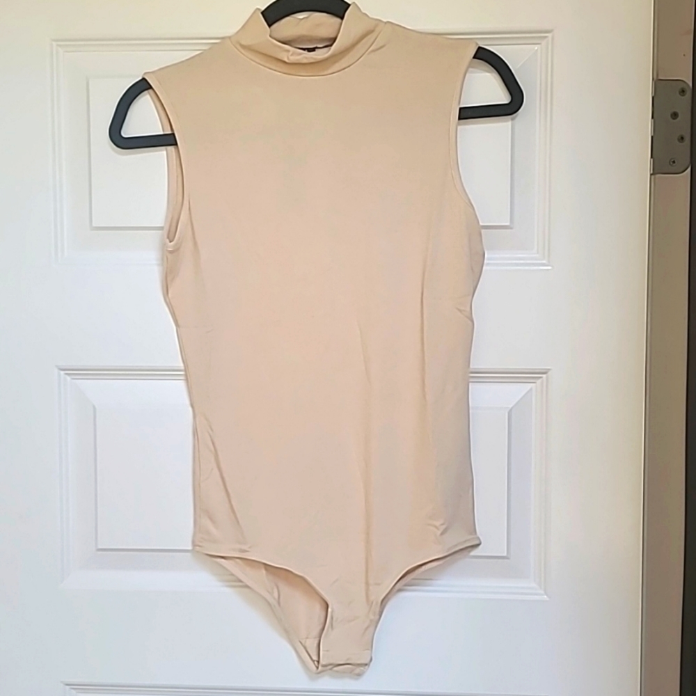 Beige body suit. NWT Gianni Bini